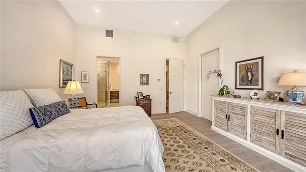 a bathroom with a granite countertop toilet a sink and a mirror