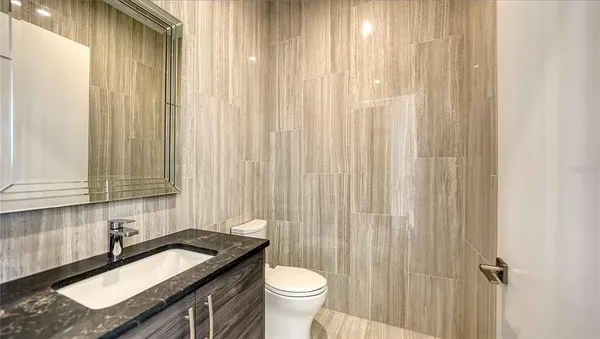 a living room with furniture a fireplace and a floor to ceiling window