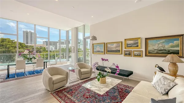 a living room with furniture and a floor to ceiling window