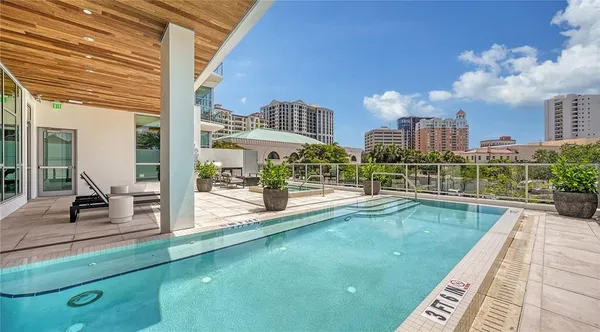 a view of a patio with couches table and chairs with wooden floor