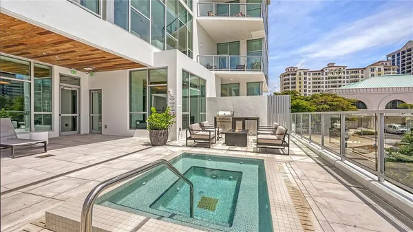 a view of a patio with couches and table and chairs with potted plants