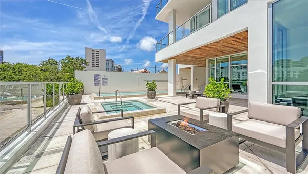 a view of a terrace with furniture and a city view