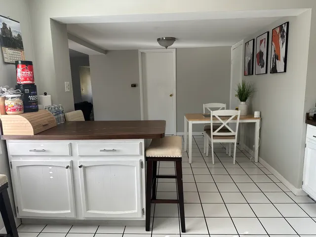 a kitchen with a table and chairs in it