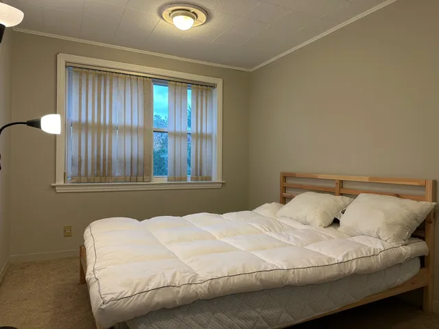 a bedroom with a bed and window