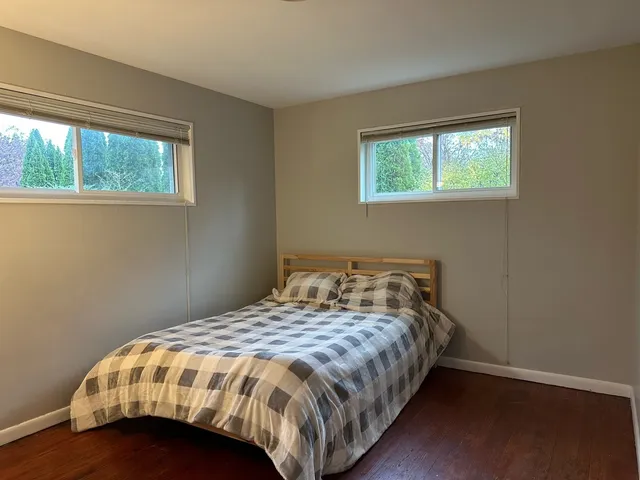 a bedroom with a bed and window