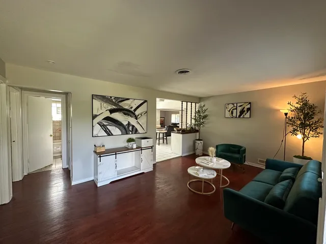 a dining room with furniture and wooden floor