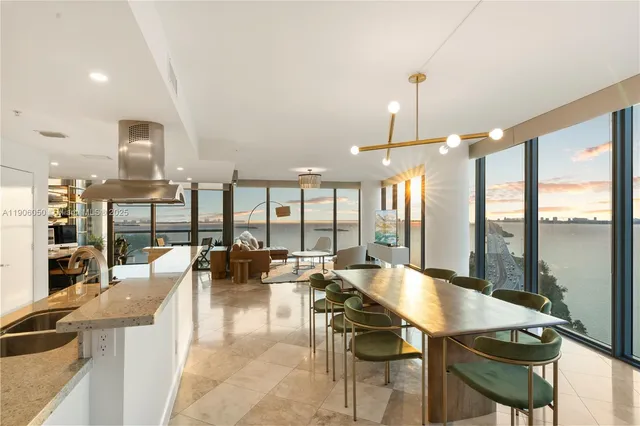 a living room with furniture a dining table and kitchen view