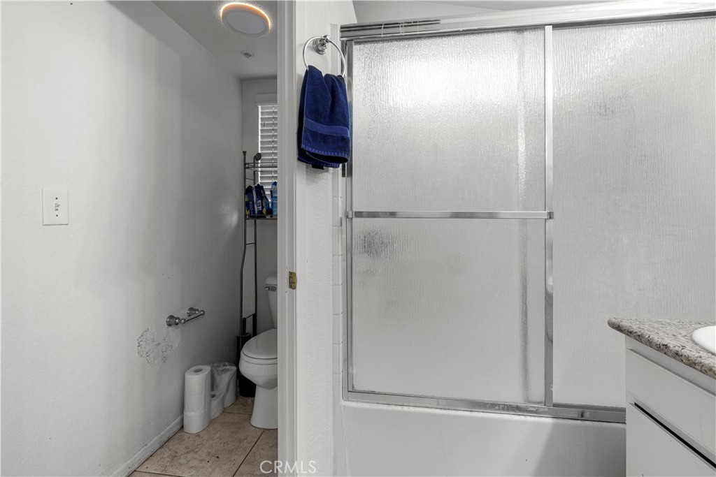 15417 Tobarra Road Fontana, CA 92337 - Photo 25 of 29 a bathroom with a shower and a toilet