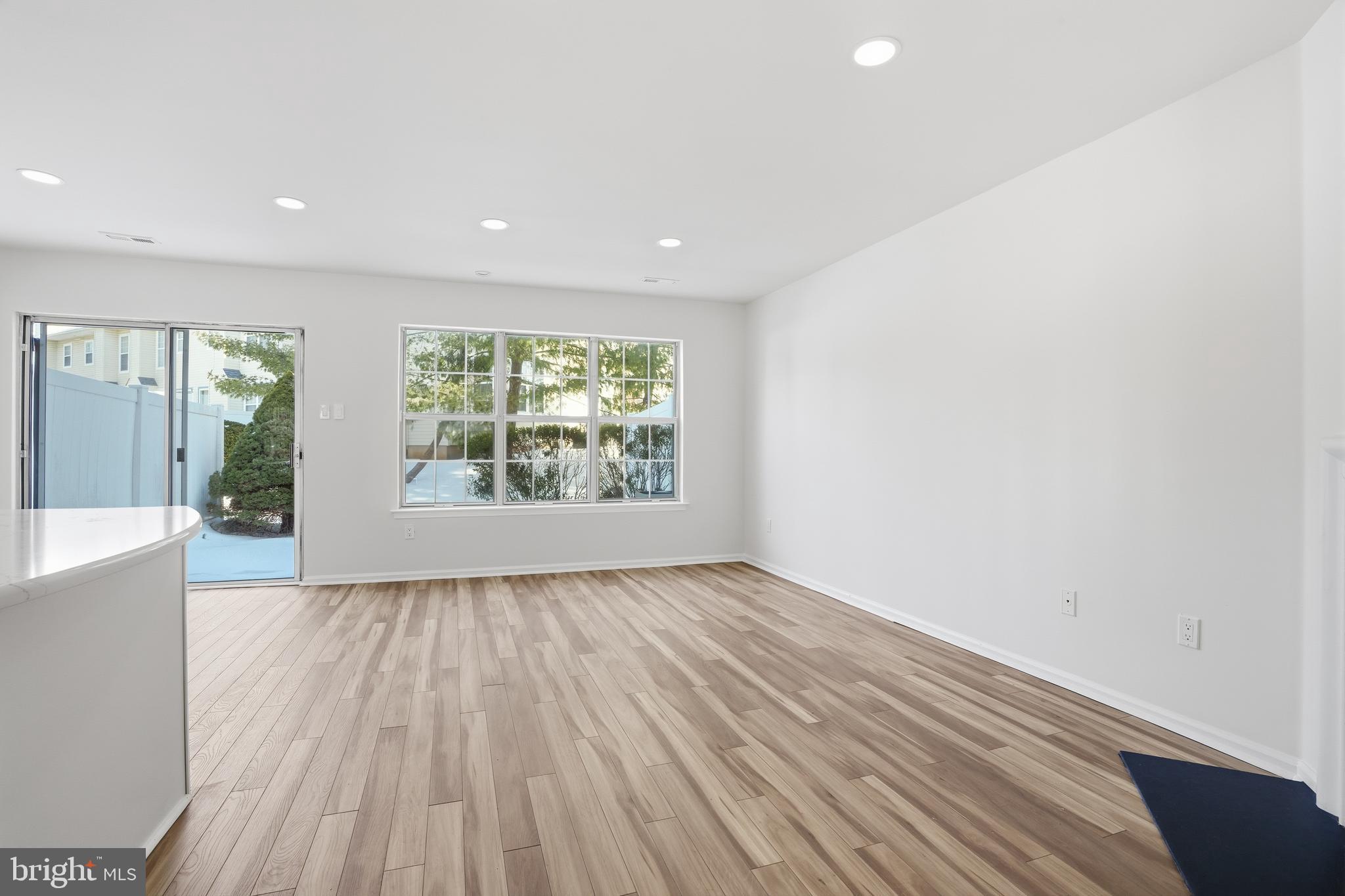 1004 Waterford Road Yardley, PA 19067 - Photo 13 of 27 an empty room with wooden floor and windows