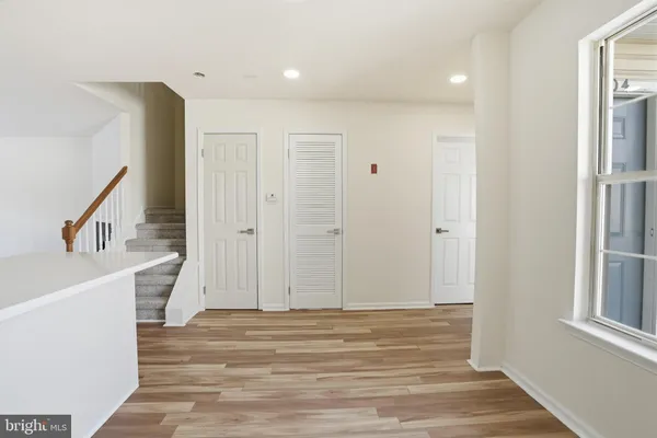 a view of entryway with wooden floor and stairs