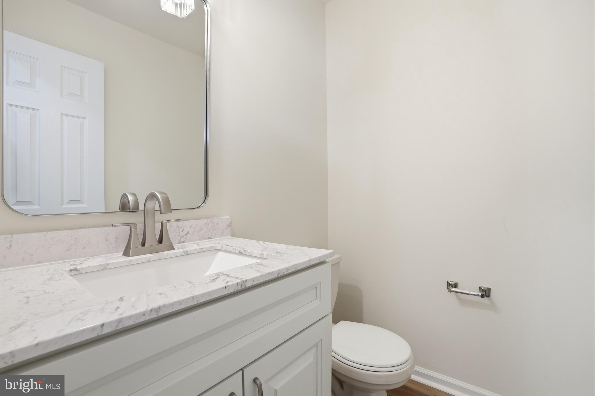 1004 Waterford Road Yardley, PA 19067 - Photo 15 of 27 a bathroom with a granite countertop toilet sink and mirror