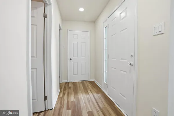 a view of a hallway with wooden floor