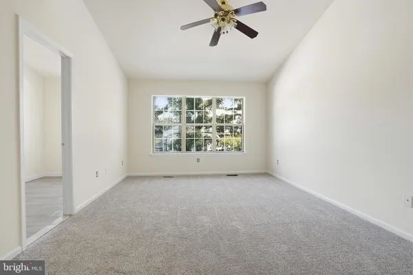 an empty room with windows and entrance