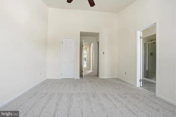 a view of an empty room and closet area