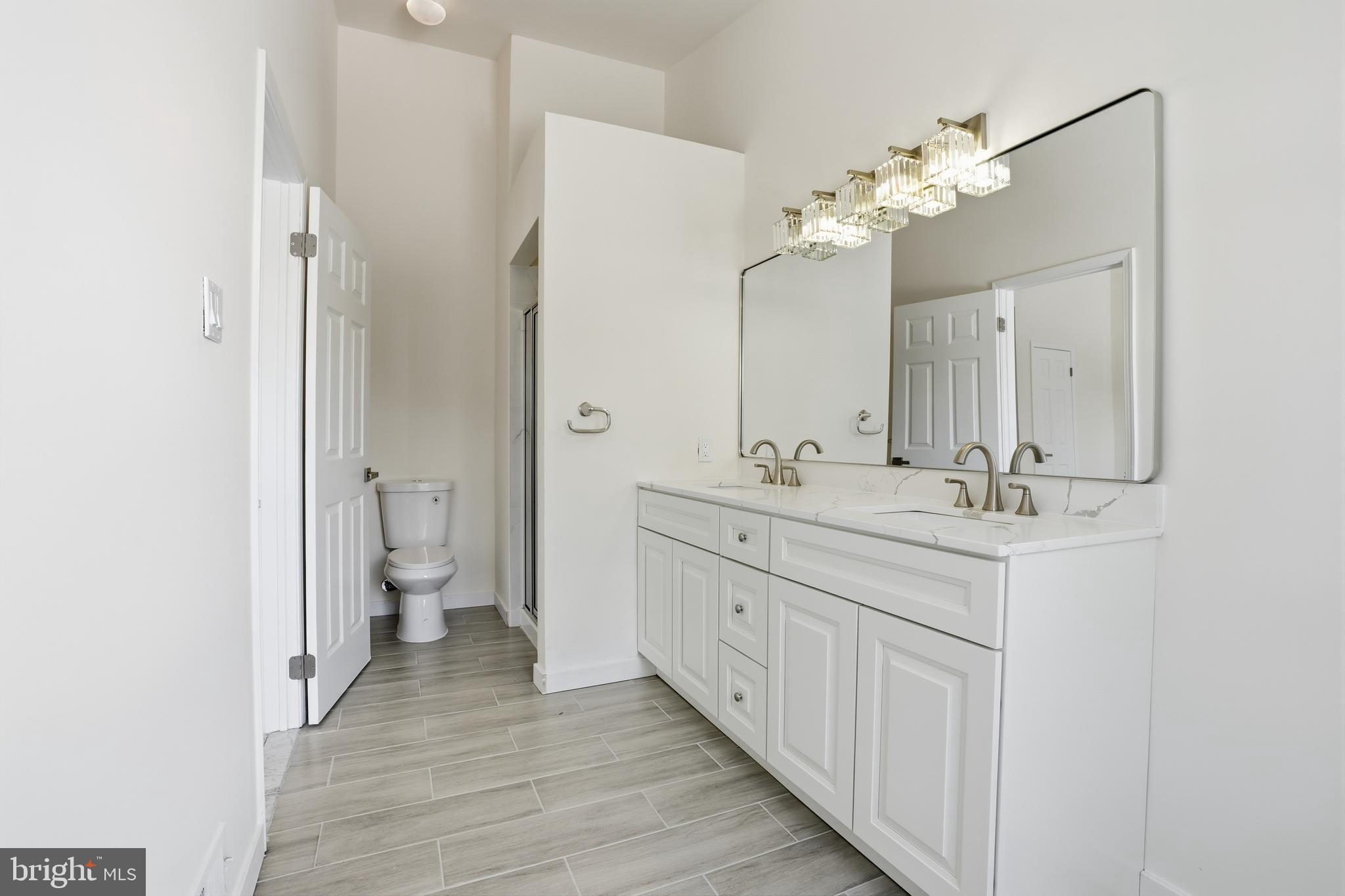 1004 Waterford Road Yardley, PA 19067 - Photo 20 of 27 a bathroom with a double vanity sink mirror and toilet