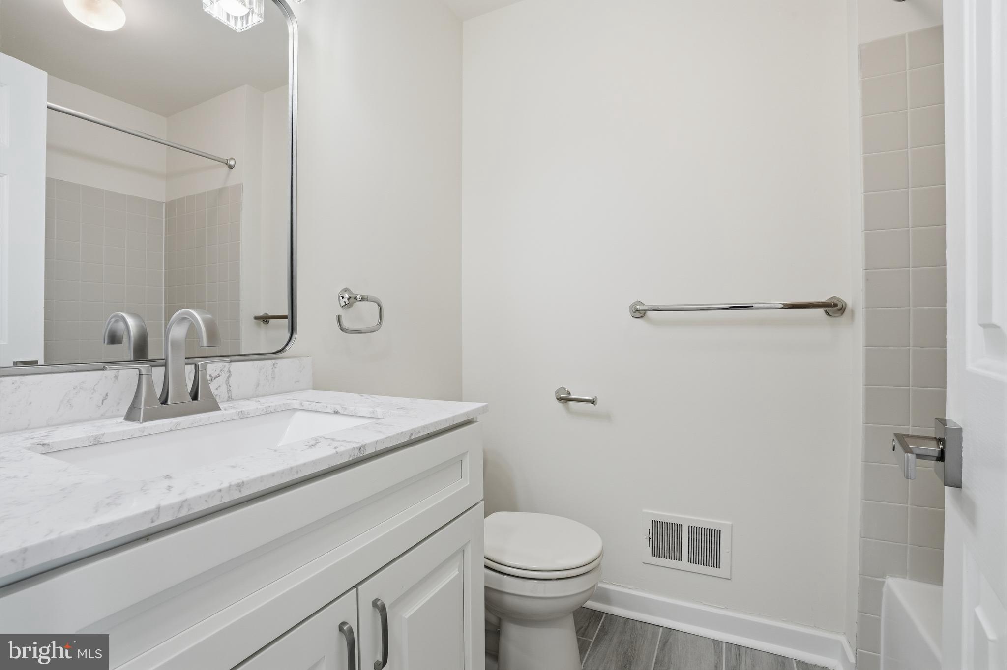 1004 Waterford Road Yardley, PA 19067 - Photo 22 of 27 a bathroom with a granite countertop sink toilet and mirror
