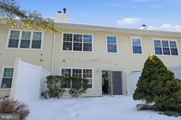 a view of a house with potted plants and a ceiling fan