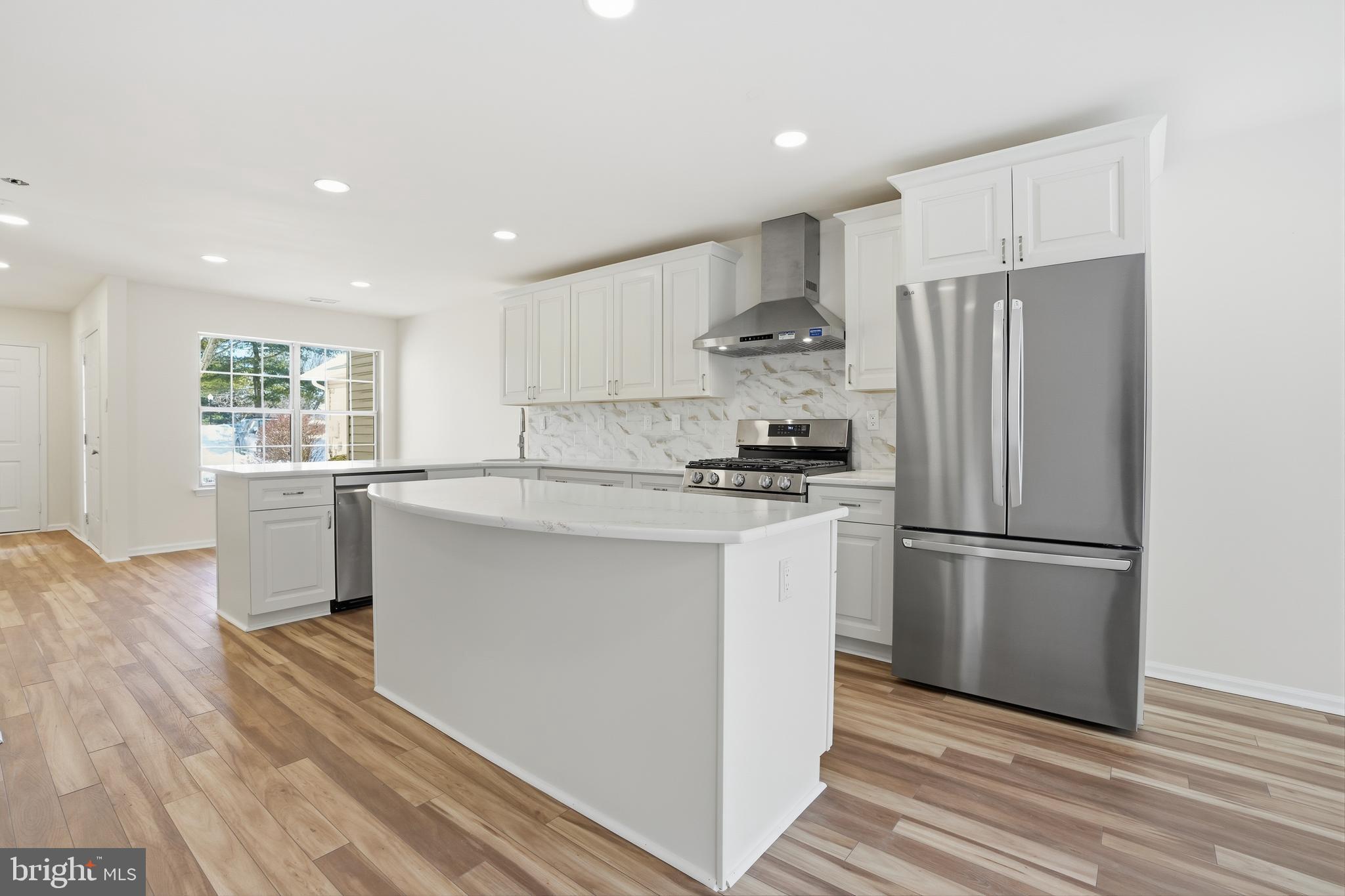 1004 Waterford Road Yardley, PA 19067 - Photo 4 of 27 a kitchen with stainless steel appliances a refrigerator stove microwave and cabinets