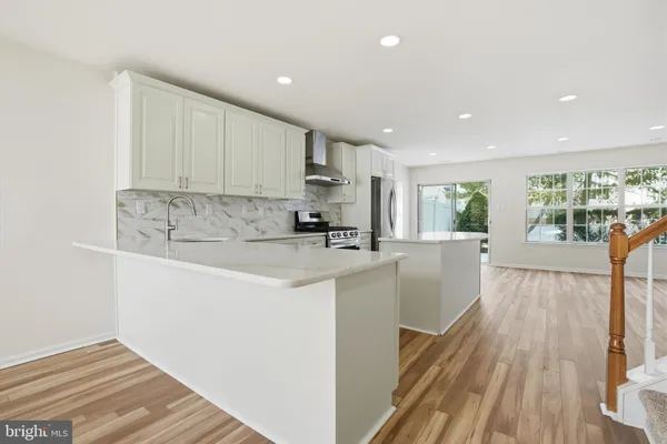 a view of kitchen with cabinets and wooden floor