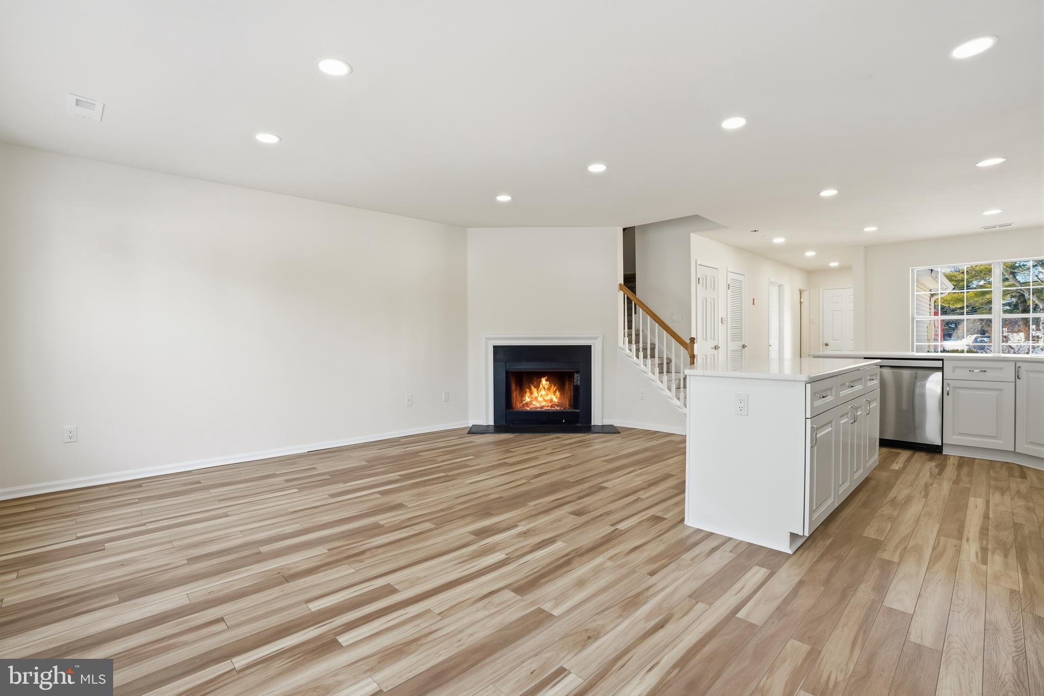 1004 Waterford Road Yardley, PA 19067 - Photo 10 of 27 a view of a kitchen with wooden floor and a fireplace