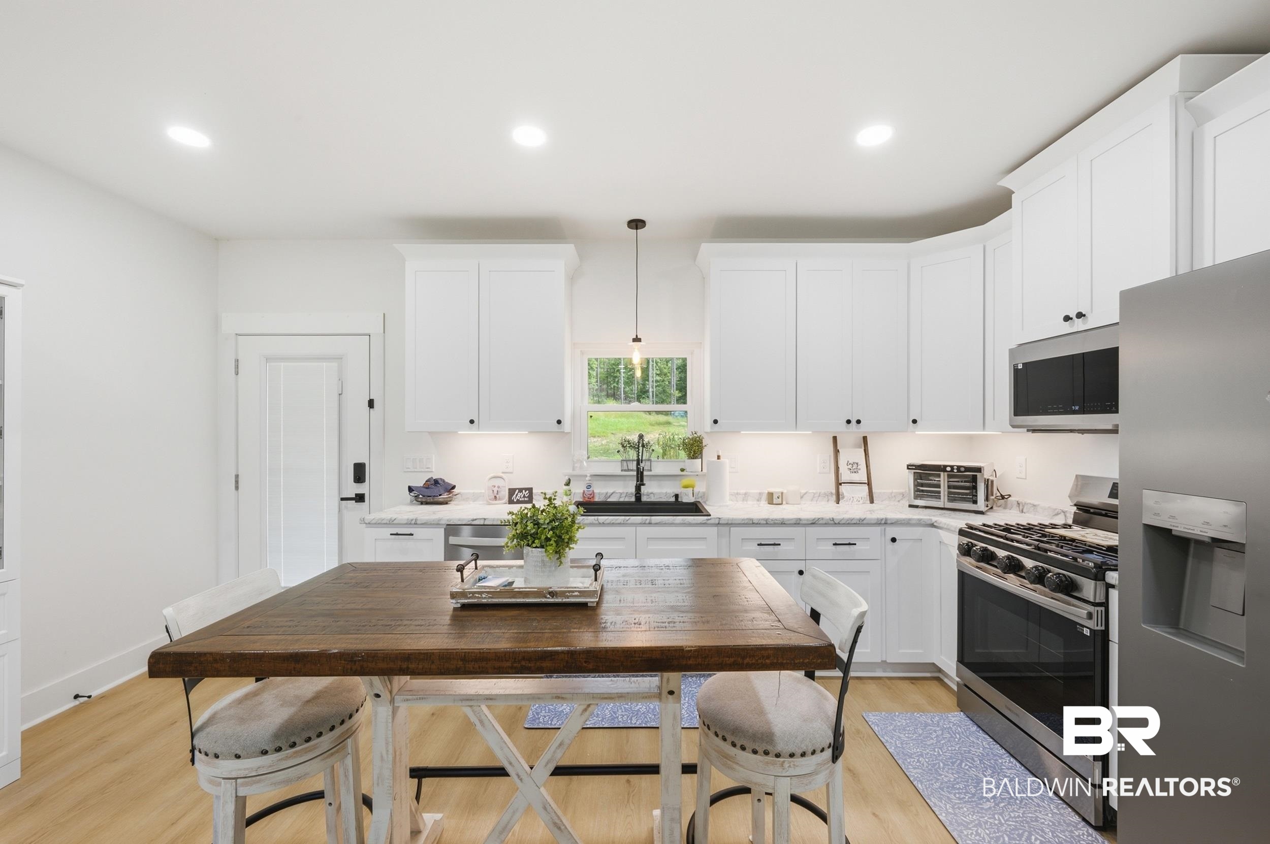 12019 Red Hill Rd Extension Bay Minette, AL 36507 - Photo 17 of 48 Kitchen featuring white shaker-style cabinetry, stainless steel appliances, a center island with a wood-finish countertop, light wood-finish flooring, and recessed lighting