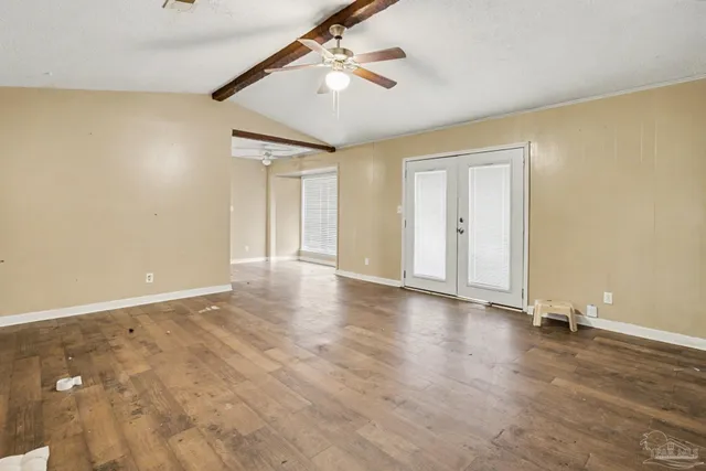 wooden floor in an empty room with a window