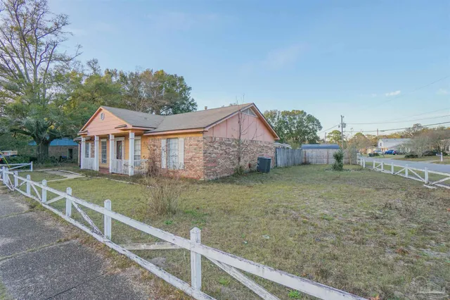 a view of a house with a yard and a garden
