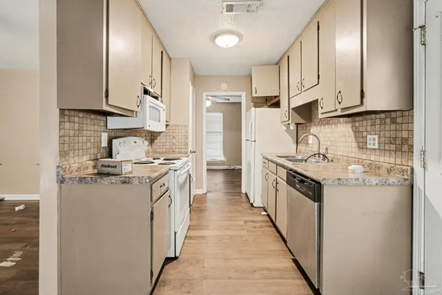 a kitchen with stainless steel appliances granite countertop a sink and a stove