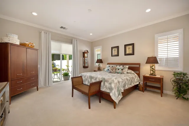 a spacious bedroom with a bed and a couch