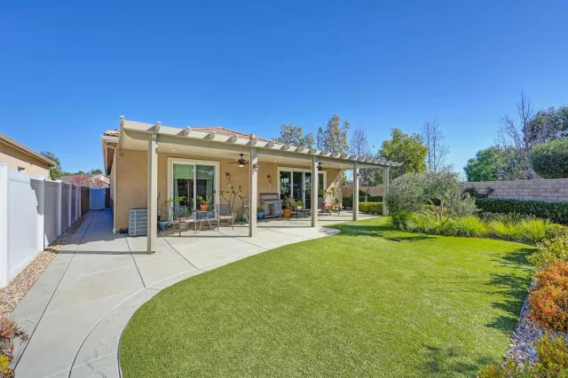 a view of a house with backyard porch and garden