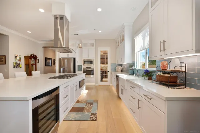 a kitchen with stainless steel appliances sink stove and cabinets