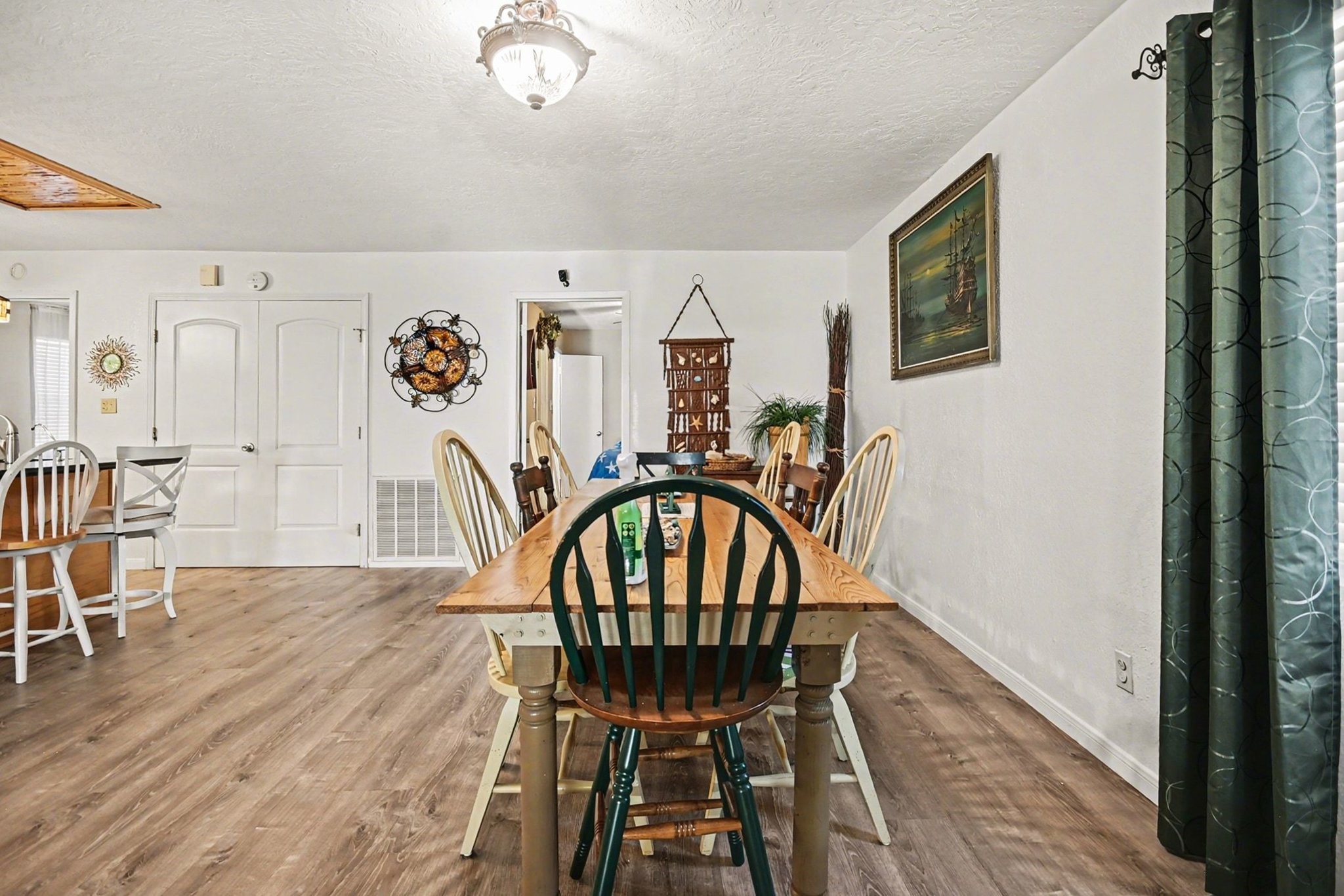 970 Wommack Drive Crystal Beach, TX 77650 - Photo 15 of 49 a view of a dining room with furniture and wooden floor