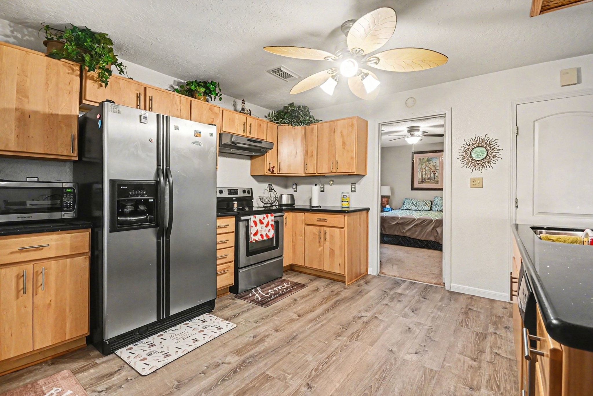 970 Wommack Drive Crystal Beach, TX 77650 - Photo 20 of 49 a kitchen with stainless steel appliances granite countertop a refrigerator a stove and a wooden floors