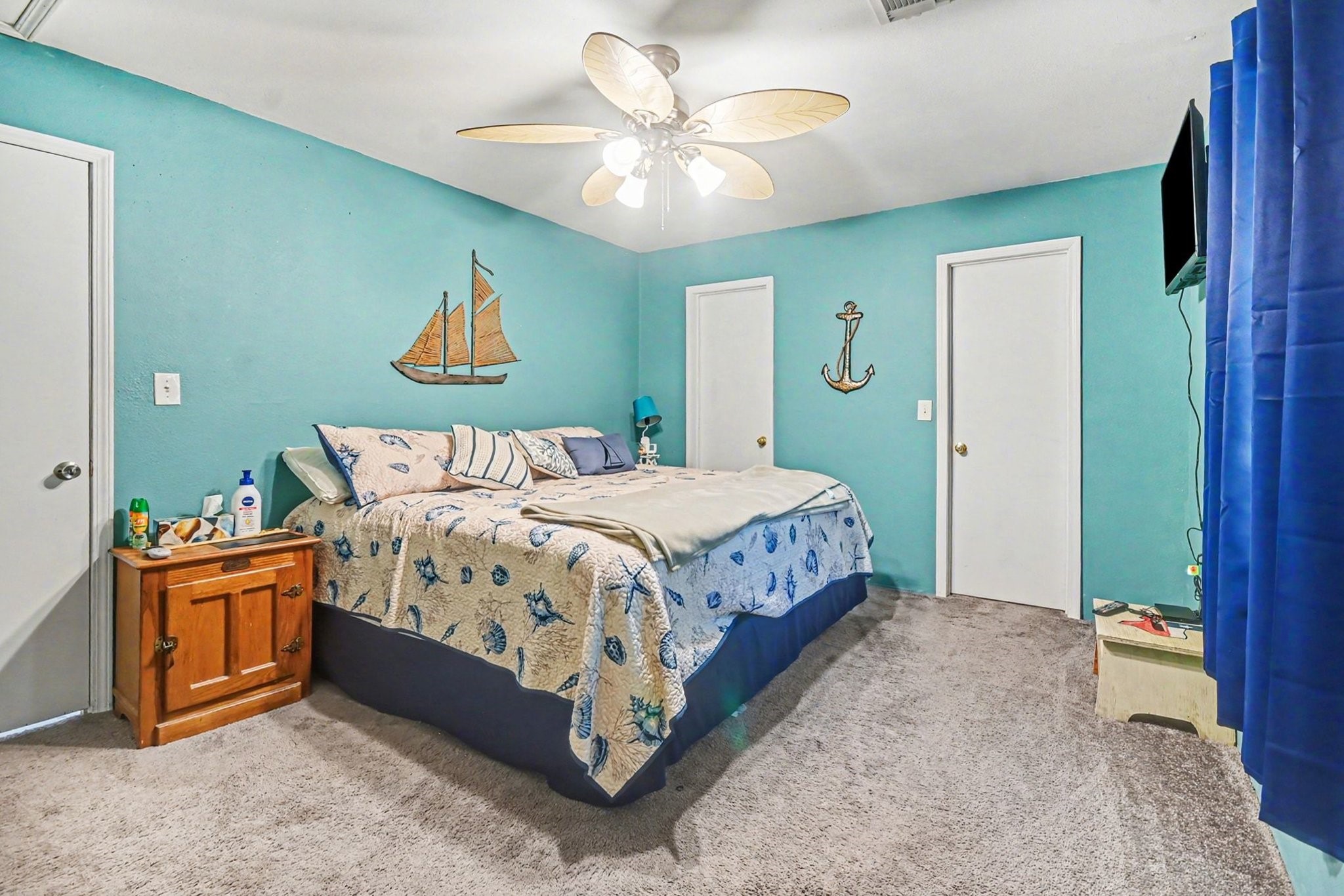 970 Wommack Drive Crystal Beach, TX 77650 - Photo 21 of 49 a bedroom with a bed and a chandelier