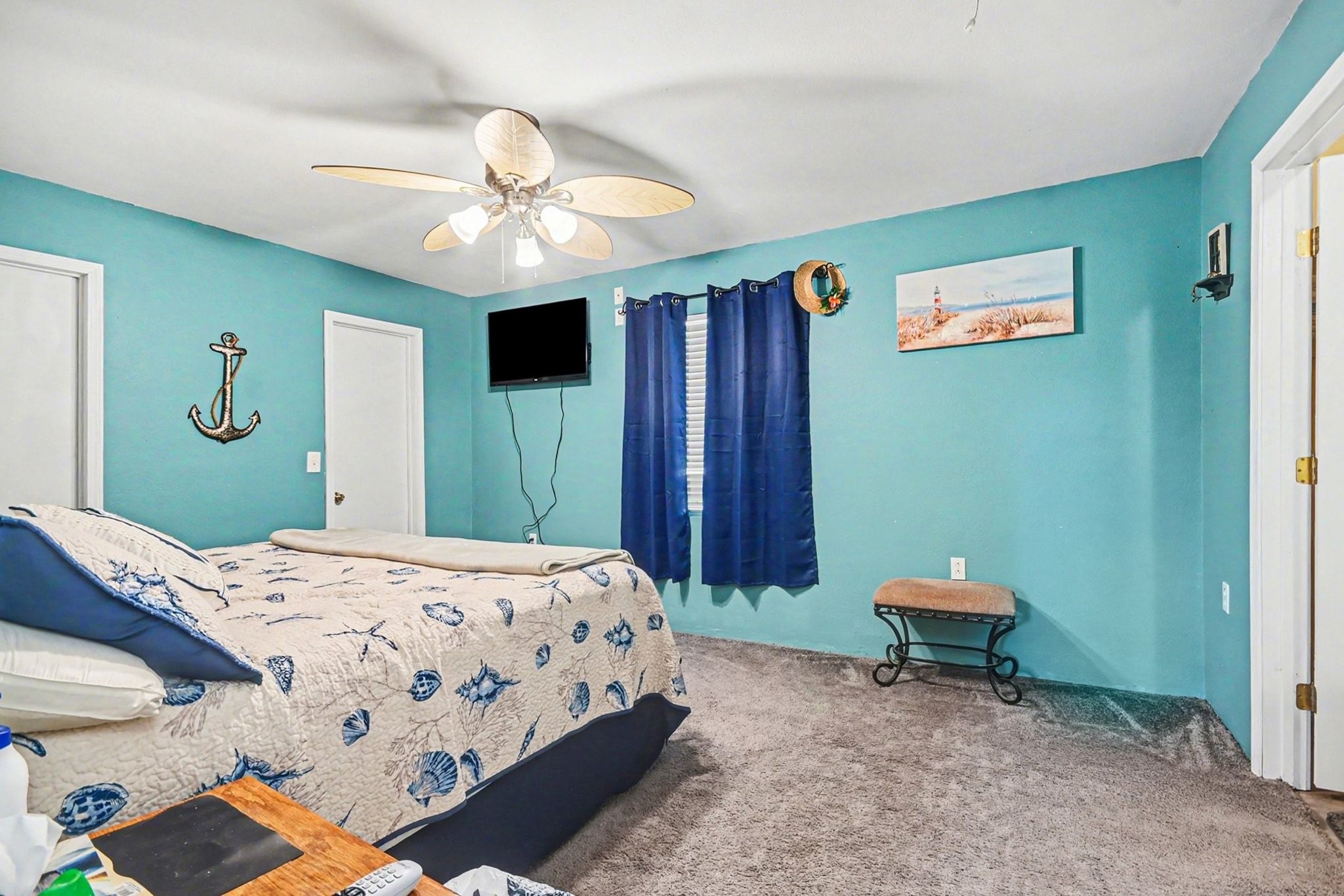 970 Wommack Drive Crystal Beach, TX 77650 - Photo 22 of 49 a bedroom with a bed and a chandelier