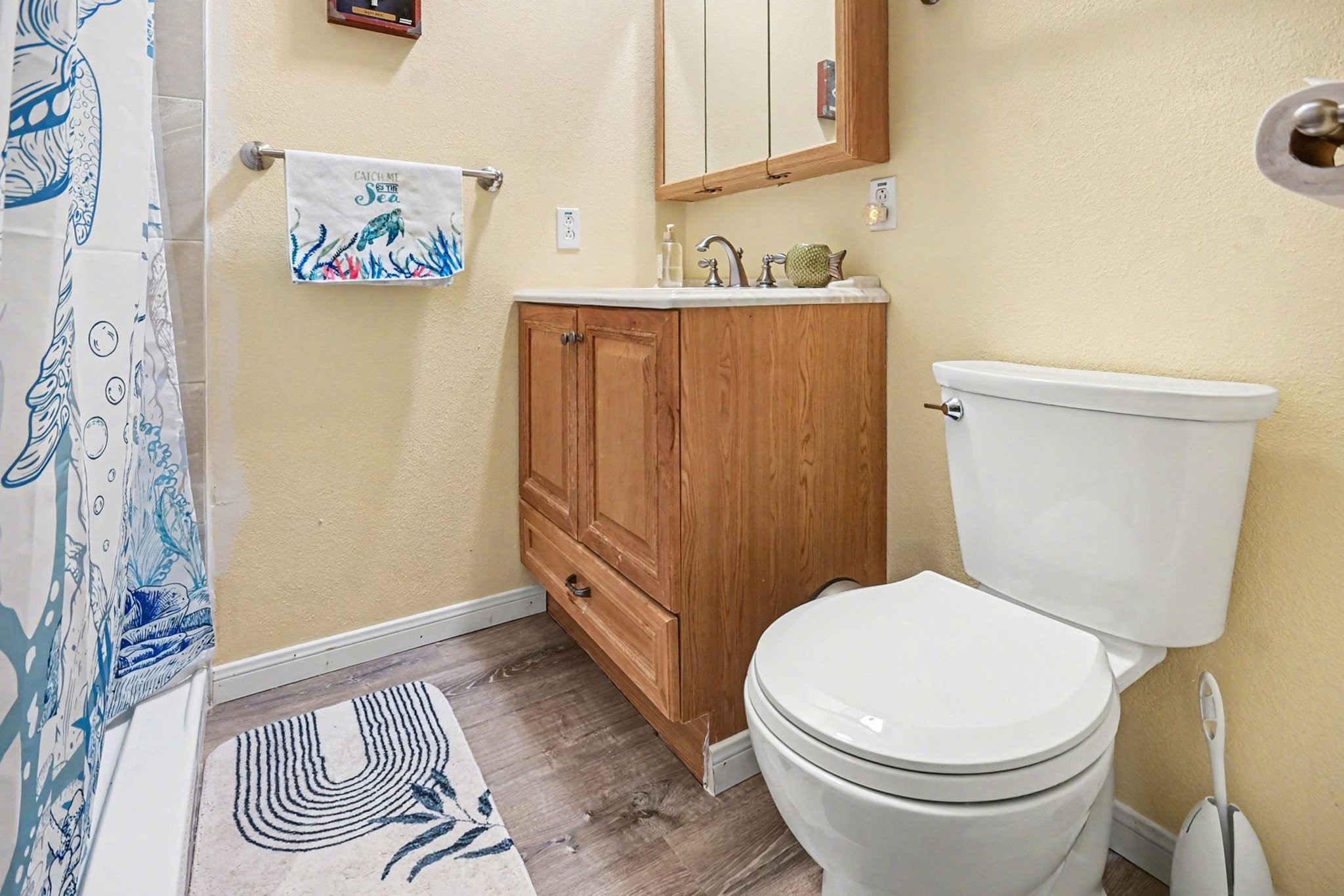 970 Wommack Drive Crystal Beach, TX 77650 - Photo 23 of 49 a white toilet sitting next to a bathroom sink