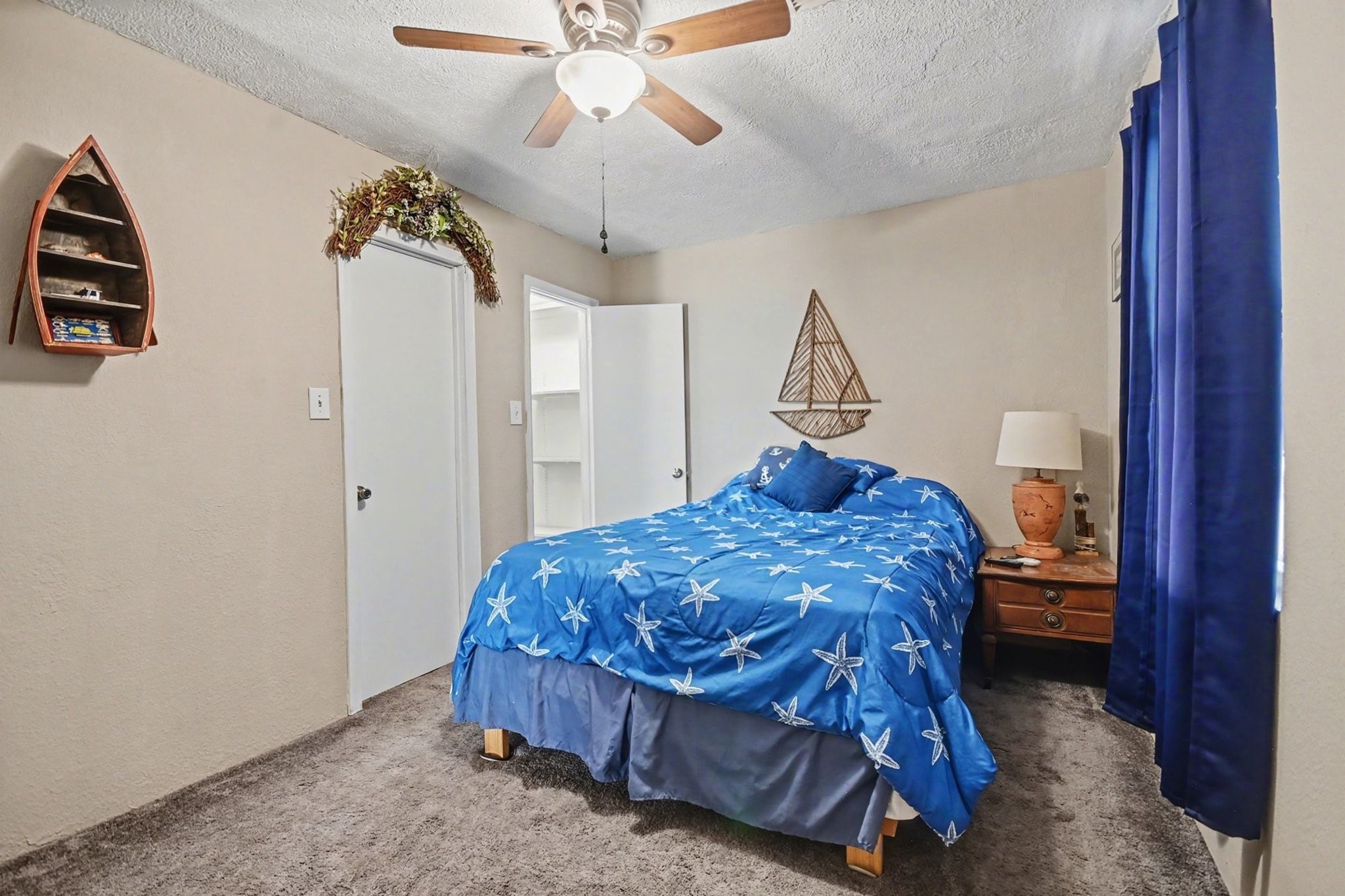 970 Wommack Drive Crystal Beach, TX 77650 - Photo 26 of 49 a bedroom with a bed and a chandelier