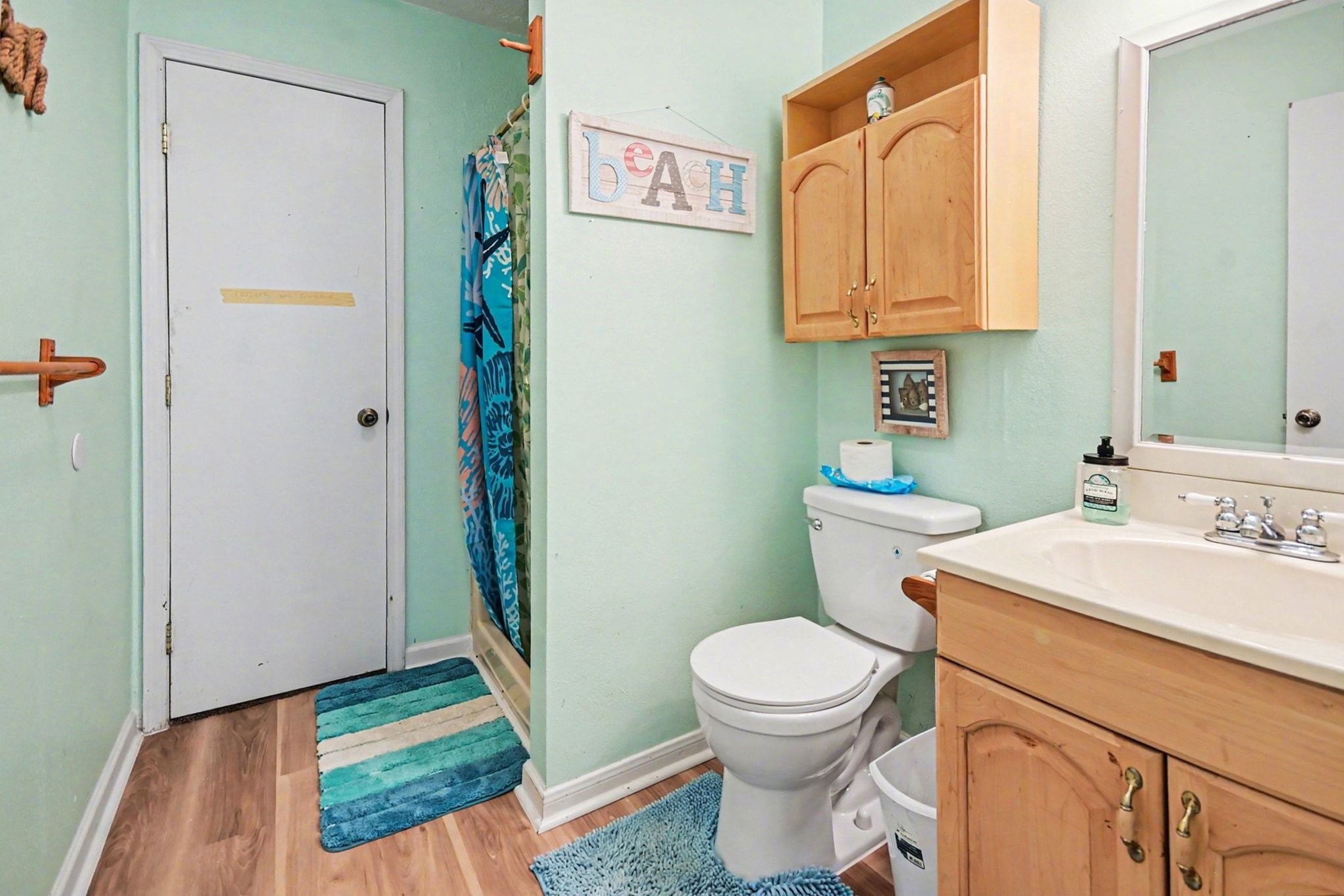 970 Wommack Drive Crystal Beach, TX 77650 - Photo 27 of 49 a bathroom with a sink a toilet and a mirror