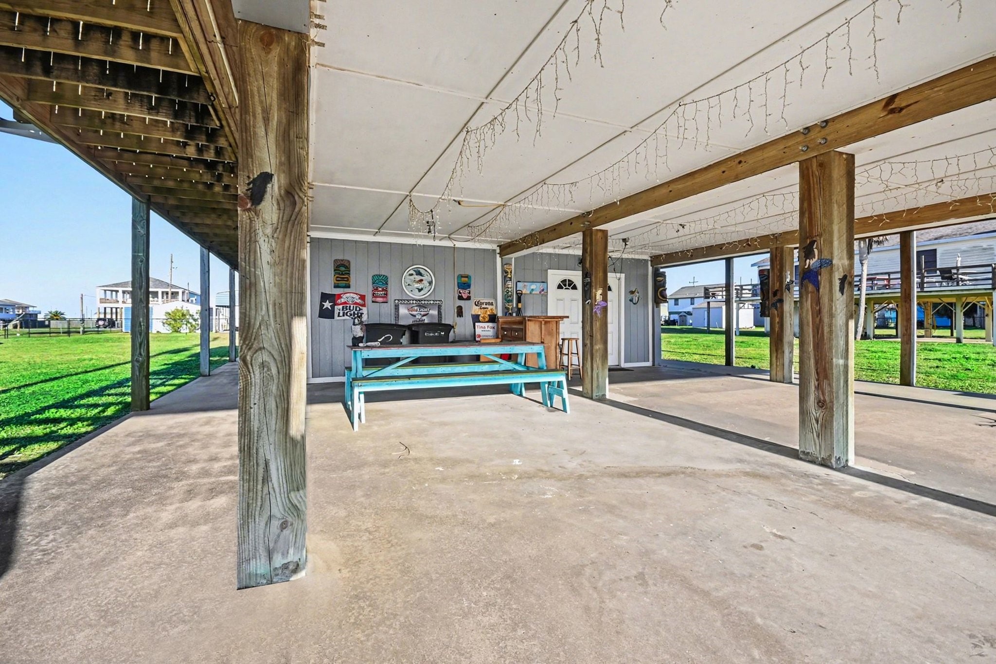 970 Wommack Drive Crystal Beach, TX 77650 - Photo 36 of 49 a view of a porch with furniture and floor to ceiling window