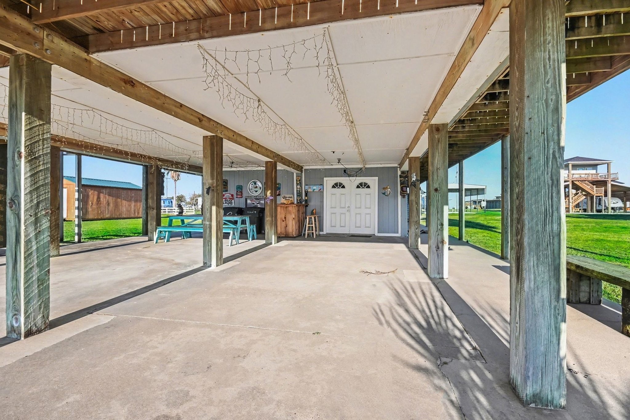 970 Wommack Drive Crystal Beach, TX 77650 - Photo 37 of 49 a view of a porch with a table and chairs