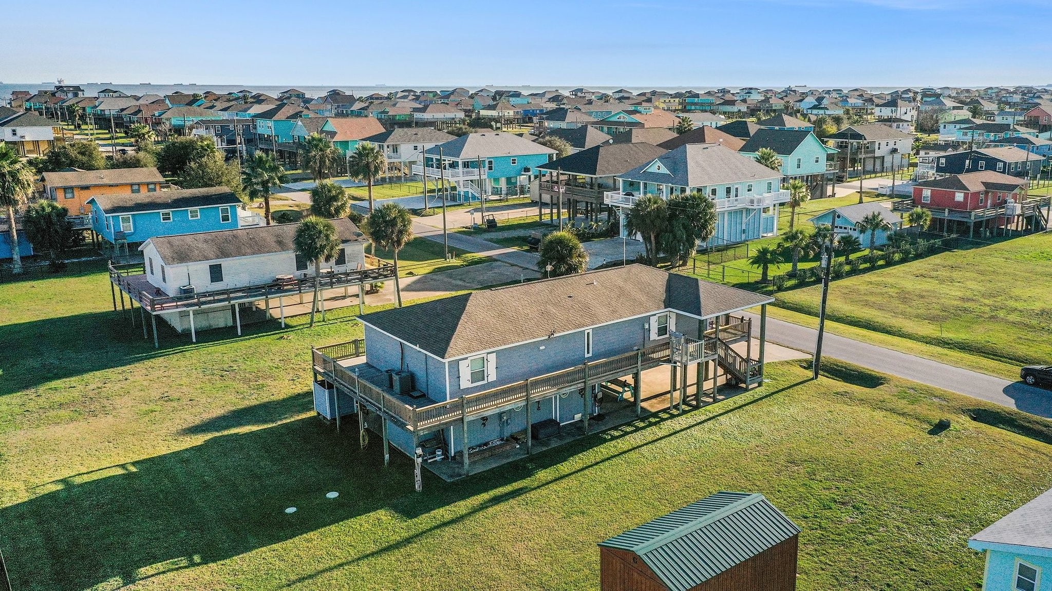 970 Wommack Drive Crystal Beach, TX 77650 - Photo 44 of 49 a view of a swimming pool with lawn chairs
