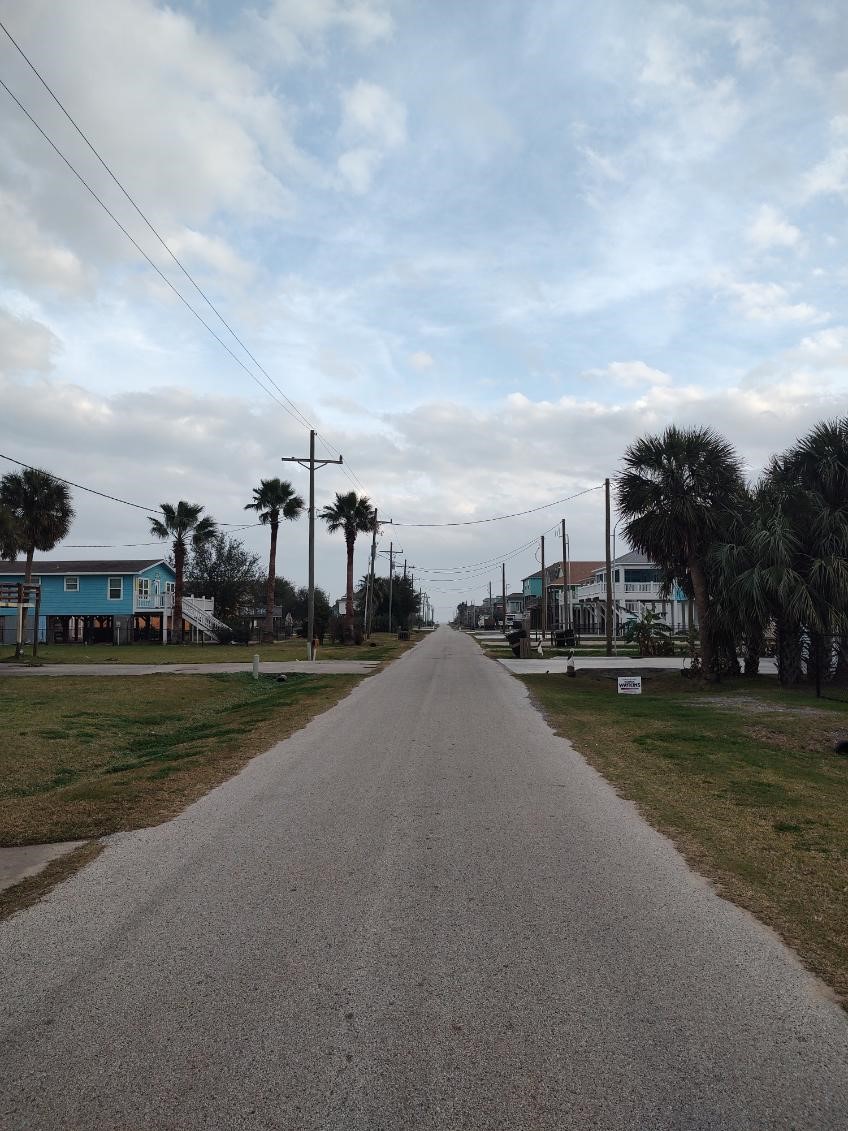 970 Wommack Drive Crystal Beach, TX 77650 - Photo 6 of 49 a view of a swimming pool and trees in the background