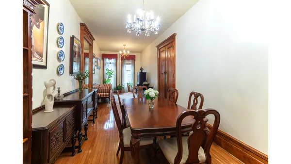 a view of a dining room with furniture and a chandelier