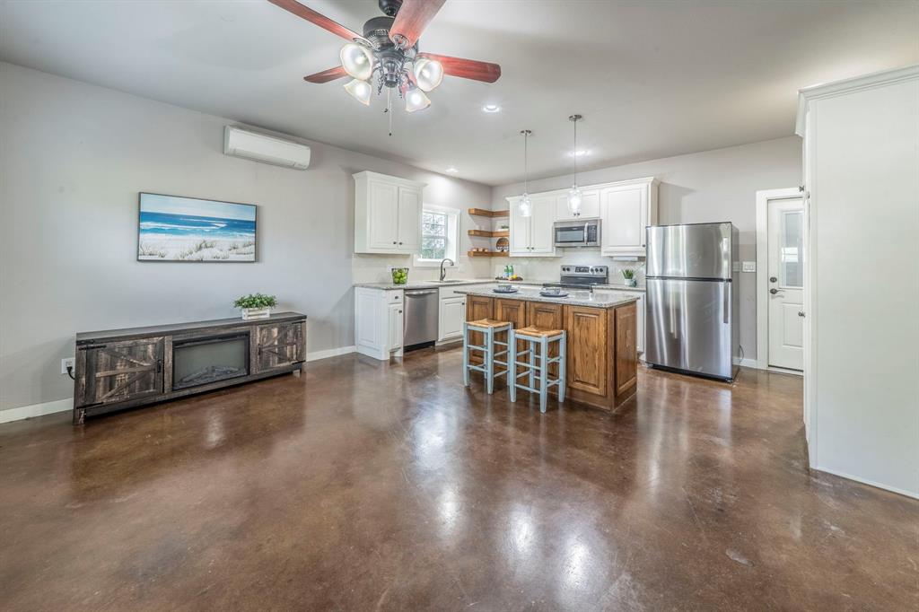 1992 Bledsoe Road Gunter, TX 75058 - Photo 28 of 40 a open kitchen with stainless steel appliances granite countertop a stove and a refrigerator