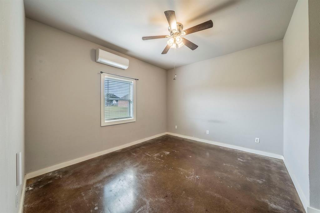 1992 Bledsoe Road Gunter, TX 75058 - Photo 30 of 40 en empty room with windows and ceiling fan