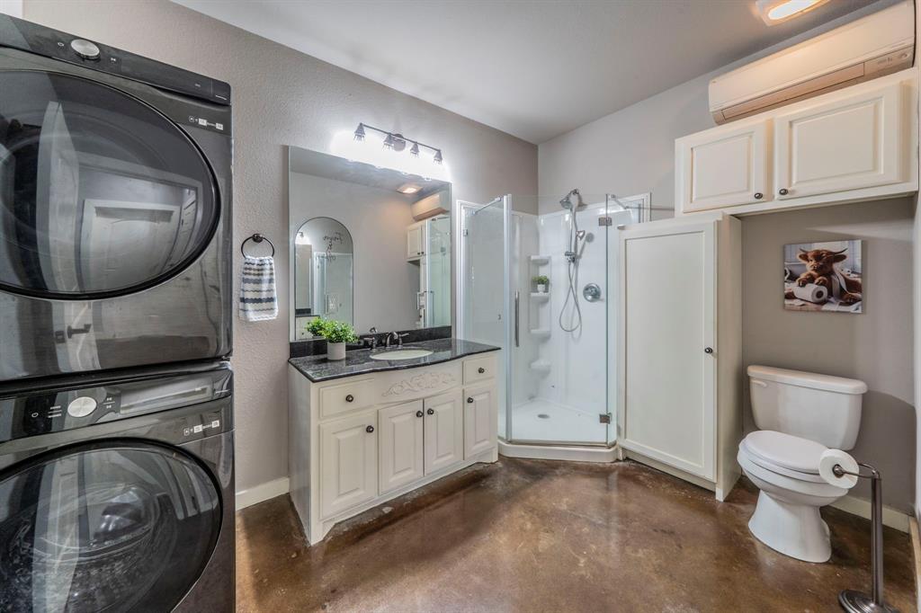 1992 Bledsoe Road Gunter, TX 75058 - Photo 31 of 40 a spacious bathroom with a toilet a sink and a mirror