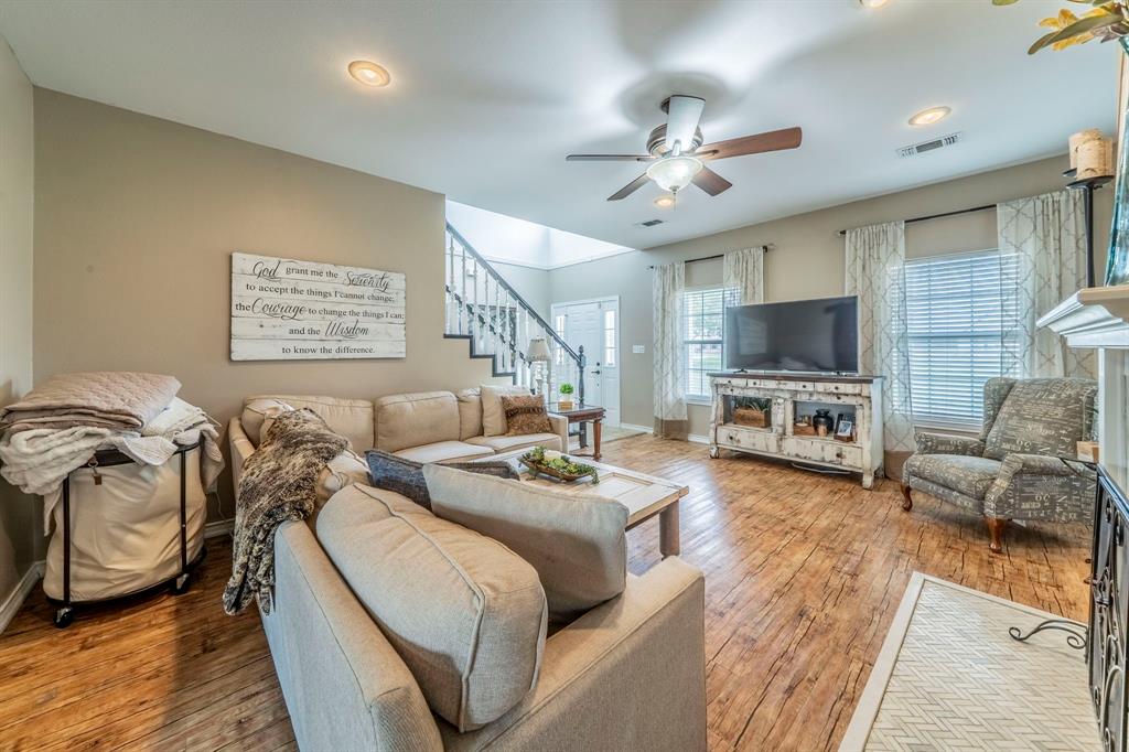 1992 Bledsoe Road Gunter, TX 75058 - Photo 7 of 40 a living room with furniture a fireplace and a flat screen tv
