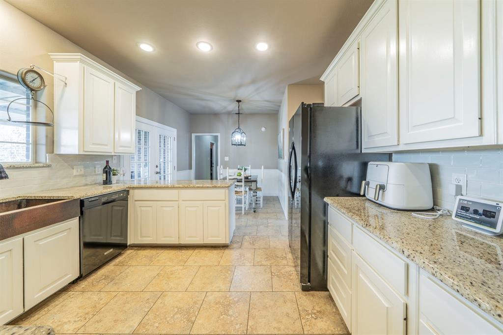 1992 Bledsoe Road Gunter, TX 75058 - Photo 8 of 40 a kitchen with a refrigerator sink and cabinets