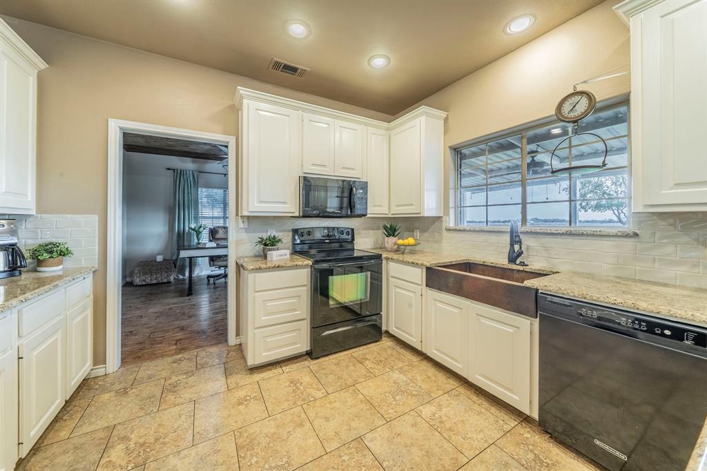 1992 Bledsoe Road Gunter, TX 75058 - Photo 9 of 40 a kitchen with a sink cabinets and window