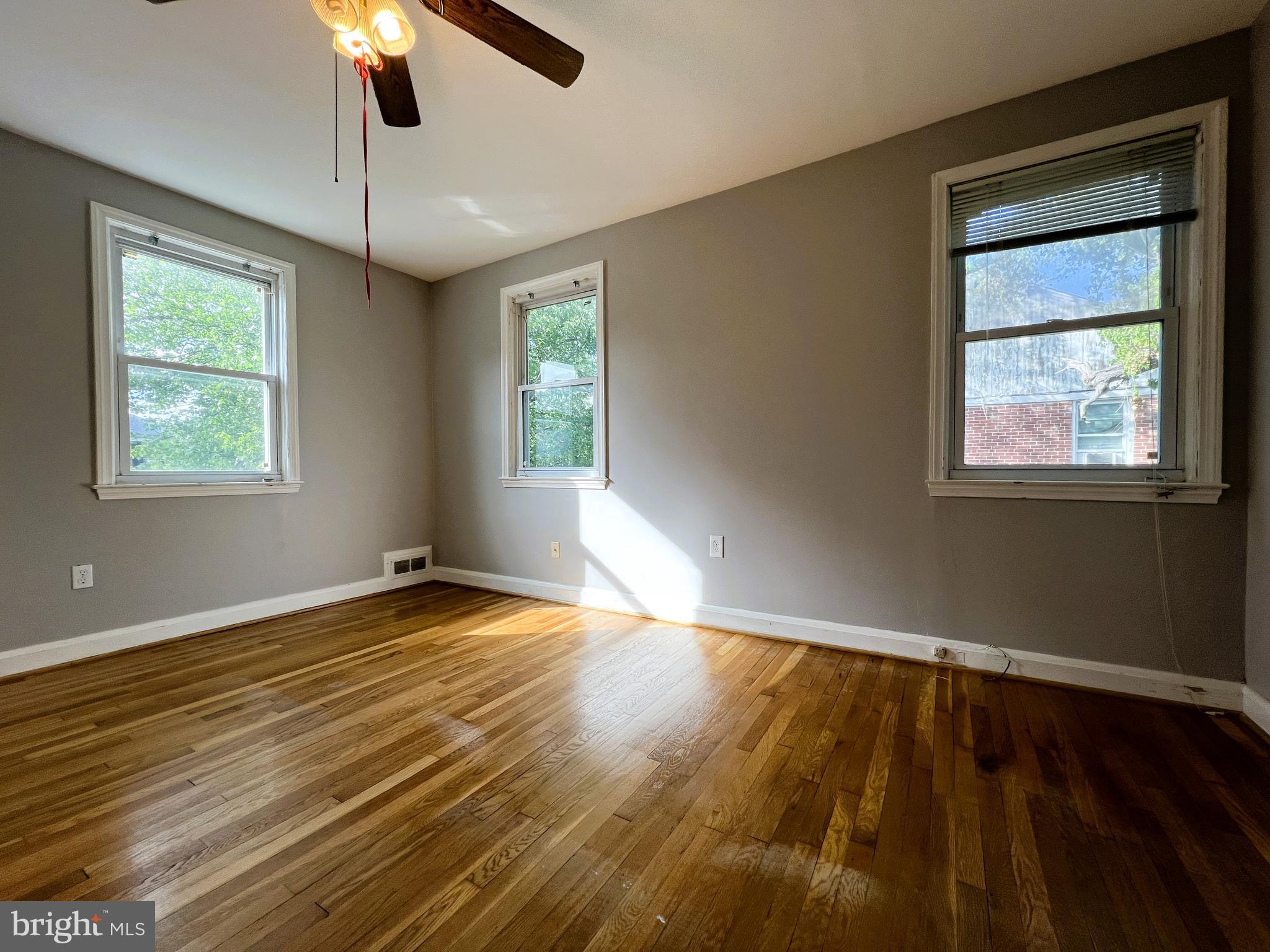 3705 Bancroft Road Baltimore, MD 21215 - Photo 24 of 50 a view of an empty room with wooden floor and a window
